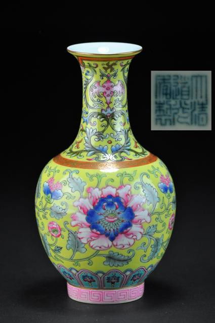 A FINE YELLOW-GROUND 'FAMILLE-ROSE' VASE .(SEAL MA: of swollen ovoid form with a slender flaring neck and pronounced splayed foot, the main body brilliantly painted with four luxuriant lotus flowers, the flourishing petals painted in delicate tones of