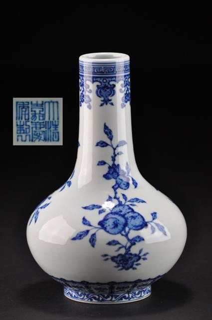 A BLUE-WHITE VASE (JIAQING MARK AND SEAL): painted in the Ming style in rich tones of cobalt blue with detached flowering peony, camellia and prunus sprays above fruiting pomegranate, lychee and peach spray,the base with an underglaze-blue sea