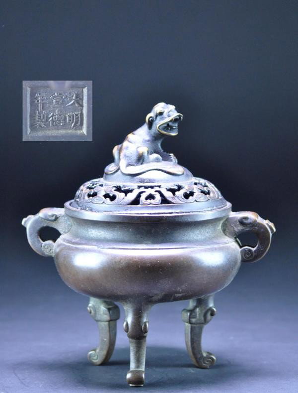 A BRONZE CENSER AND COVER. 18 CENTURY: A BRONZE CENSER AND COVER. 18 CENTURY Ssupported with three elephant heads with trunks forming the columnar legs. with one branch in openwork together with either a lion cover.six character mark on ba