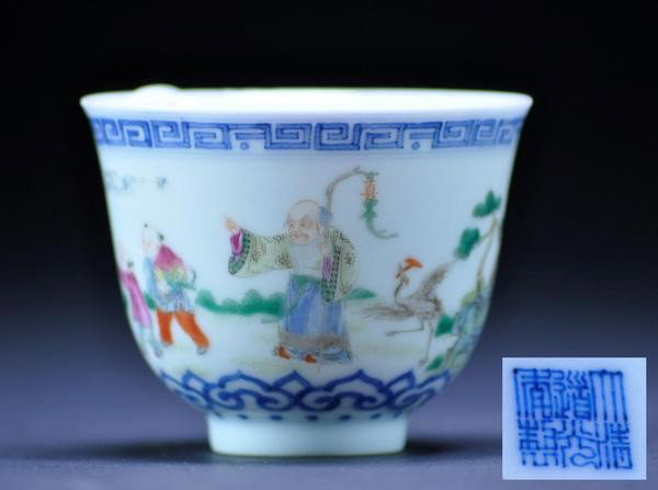 A FAMILLE-ROSE WINE CUP. (MARK AND PERIOD OF DAO: A FAMILLE-ROSE WINE CUP. (MARK AND PERIOD OF DAOGUANG) Of deep, slightly flared form, painted on one side with a immortal and attendants .six character mark on base.2 1/4''in H