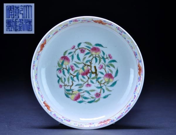 A FAMILLE -ROSE DISH. (MARK AND PERIOD OF QIANLON: A FAMILLE -ROSE DISH. (MARK AND PERIOD OF QIANLONG) finely painted with bats and fruiting branches of peach.six character mark on base. 1 1/4''x6 1/2''in