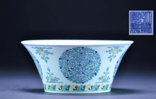 A FINE DOUCAI 'FRUIT TREE MEDALLION' BOWL. (SEAL: A FINE DOUCAI 'FRUIT TREE MEDALLION' BOWL. (SEAL MARK AND PERIOD OF QIANLONG) finely potted with steep flaring sides, painted with five roundels in the form of fruiting trees bearing peach, mulberry a