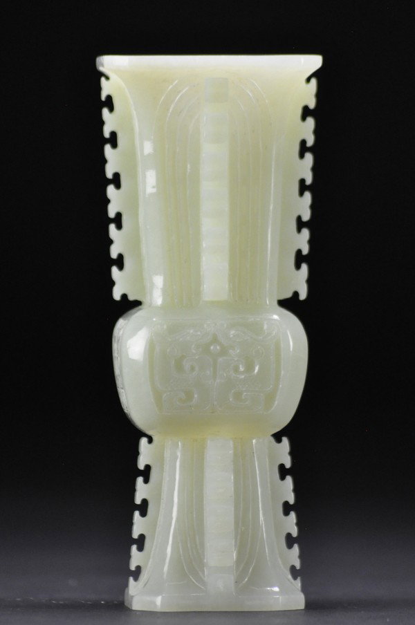 A FINE IMPERIAL ARCHAISTIC WHITE JADE VASE, FANG ZU: - A FINE IMPERIAL ARCHAISTIC WHITE JADE VASE, FANG ZUN Of square form, carved in low relief with a taotie mask on each facet of the mid-section, all between lappets with archaistic scrolls spreading o