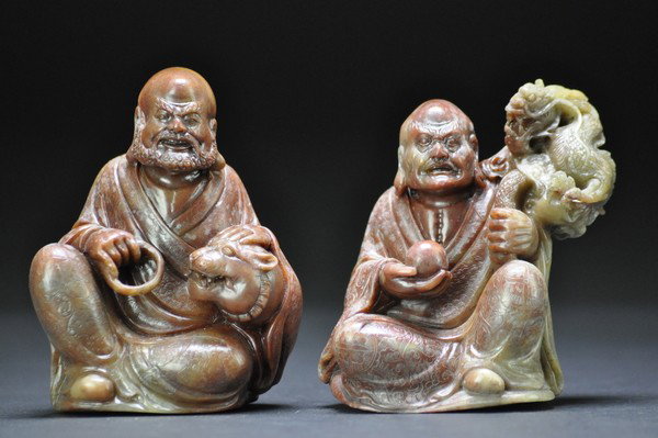 TWO SOAPSTONE LUOHANS (QING DYNASTY): - TWO SOAPSTONE LUOHANS (QING DYNASTY) The seated figure shown lion and dragon by him , his loosely draped robes incised with foliate roundels and borders and his shawl with clouds, with fine stipplin