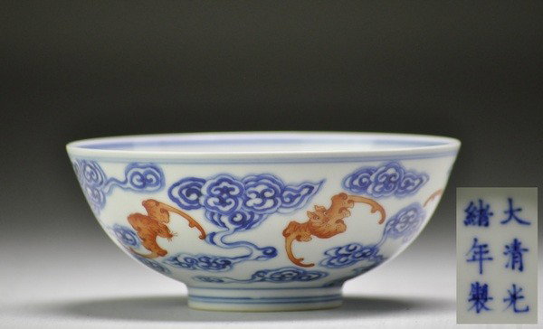 A BLUE AND WHITE IRON-RED BOWL.( MARK AND PERIOD O: - A BLUE AND WHITE IRON-RED BOWL.( MARK AND PERIOD OF GUANXU) painted with numerous bats amid brightly blue and white clounds,GuangXu mark on base.