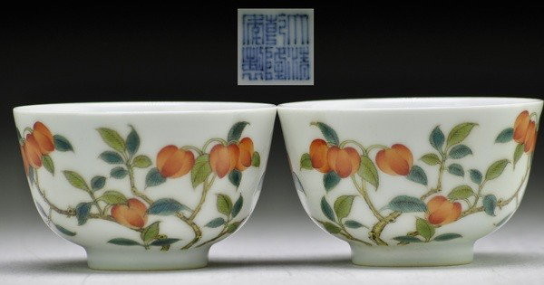 A PAIR OF FAMILLE- ROSE WINE CUPS .(MARK AND PERIOD : Each delicately painted with a spray of different colored of the peach trees and butterflys.2'' H 3 1/4'' Diam