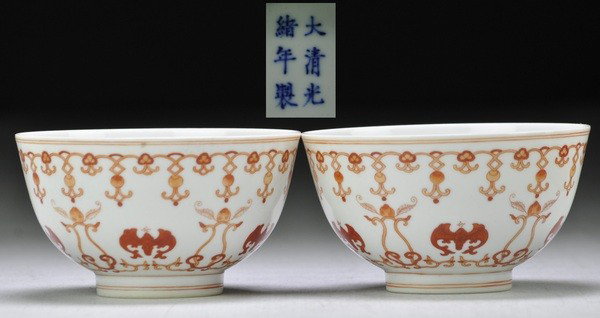 A PAIR OF IRON-RED BOWLS.(MARK AND PERIOD OF GUANGX: the body finely painted with bats and peaches,six character mark on base.2 3/4''H 5''Diam