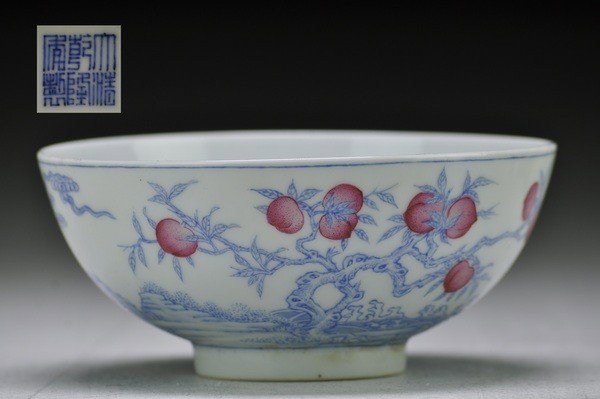 A FINE PAIR OF IRON-RED-DECORATED BLUE AND WHITE BO: The deep rounded sides decorated on the exterior in iron-red with peaches and bats positioned above a band of conjoinedpeach tree in underglaze blue.2 1/8''H 4 3/4''Diam.