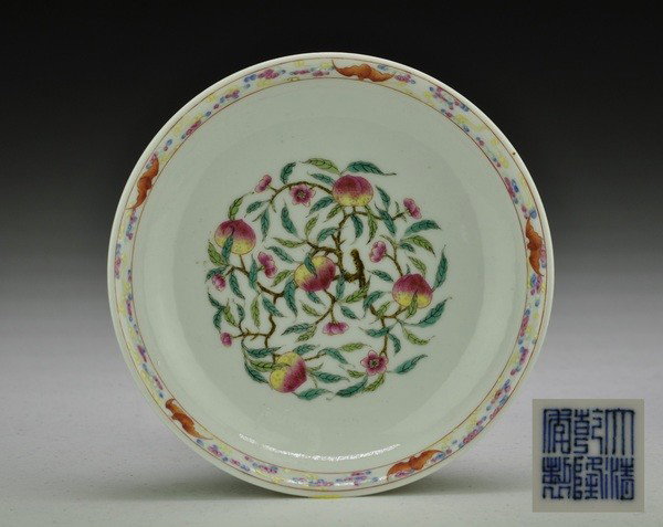 A FAMILLE-ROSE DISH.(MARK OF QIANLONG): Finely painted with bats and fruiting branches of peach,six character mark on base.1 1/4''H 6 1/2'' Diam.