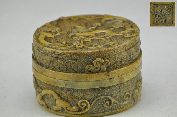 A SOAPSTONE BOX AND COVER.(QIANLONG MARK): The surface of the box well-carved dragons and four character mark on base.2 1/4''H 3 1/4'' Diam