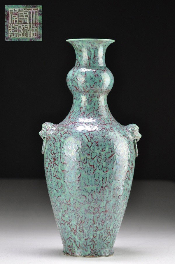 A ROBIN'S-EGG BLUE-GLAZED PEAR-SHAPED VASE.(MARK O: Raised on a slightly splayed foot with a bow-string band at the base of the neck which continues under the mask and loop handles, covered with a finely mottled opaque glaze of turquoise and purplish-b