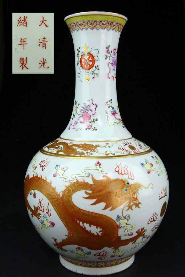 A FAMILLE-ROSE BOTTLE VASE.(MARK AND PERIOD OF GUAN: Each brightly enameled with dragons and phoneix in flight between bands of ruyi encircling the mouth, dragons on the shoulder, and upright lappets around the base.six character mark on base.15 1/8''in