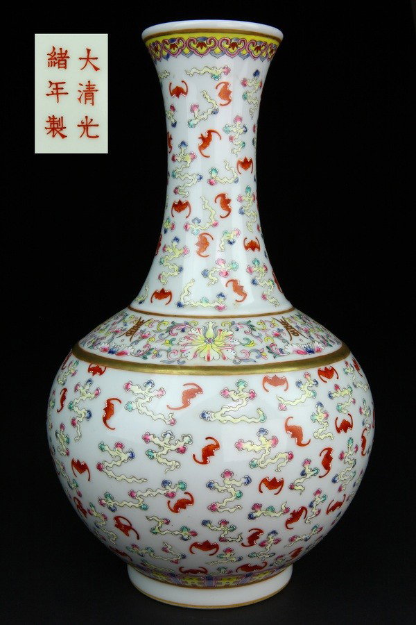 A FAMILLE -ROSE BOTTLE VASE.(MARK AND PERIOD OF GU: Finely painted with a dense allover pattern of iron-red bats in flight amidst trailing multicolored clouds, all between borders of stylized lappets around the base and ruyi heads around the mouth.15 3