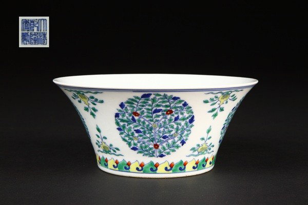 A DOU CAI BOWL.(MARK AND PERIOD OF QIANLONG): with flared, outward-curved sides painted with five roundels of stylized flowering or fruiting trees separated by pomegranate sprays above a band of overlapping petals. 2 3/4''H 6 1/4''Diam