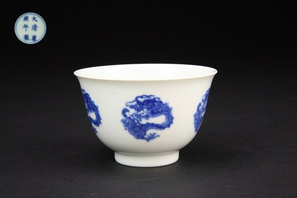 A BLUE AND WHITE DRAGON CUP.(MARK AND PERIOD OF KA: the interior and exterior finely painted with dragons design,kangxi mark on base.2 3/8''H 3 5/8''Diam.