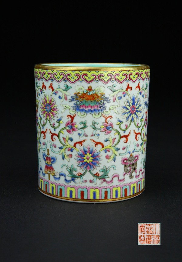 A FAMILLE-ROSE BRUSHPOT.(MARK AND PERIOD OF JIAQIN: the sides decorated with the eight Buddhist Emblems arranged above and below four lotus spray,the bajixiang in lower register alternating with further smaller lotus sprays,the interior covered in turq