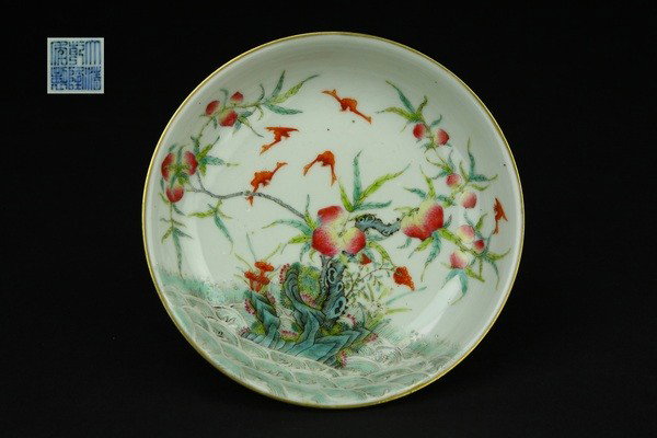 A FAMILLE-ROSE DISH.(MARK AND PERIOD OF QIANLONG): thinly potted with low rounded sides rising from a shallow foot ring to a flaring rim with a gently rounded edge,finely painted with five bats and peaches ,QianLong mark on base.1 1/4''H 5 1/2''Diam