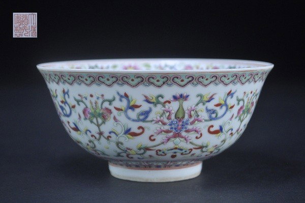 A FAMILLE-ROSE BOWL.(MARK AND PERIOD OF DAOGUANG): The exterior well painted with four lotus sprays , finger citron and pomegranate, suspending a chime, all below a narrow ruyi border, the interior with a central medallion incorporating flowerheads, p