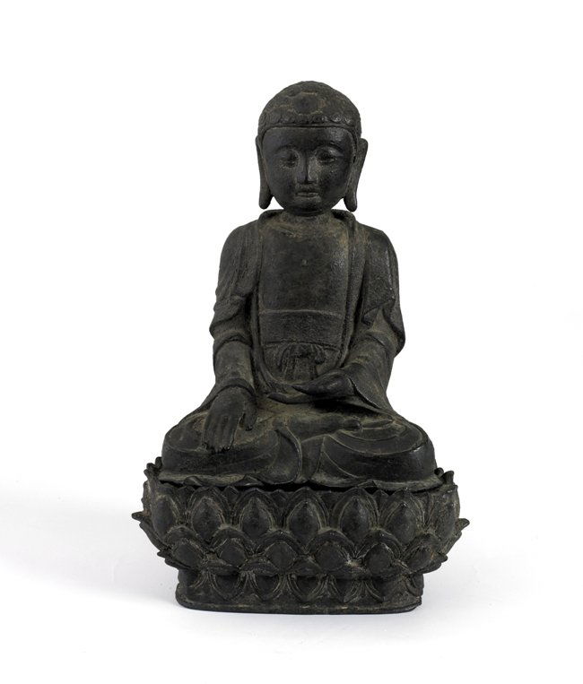 A BRONZE FIGURE OF BUDDHA, MING DYNASTY: Shown seated in dhyanasana on a separate lotus base with hands held above the lap, with a wan emblem incised in the center of the bared chest, wearing loosely draped robes and a tied dhoti with foliat
