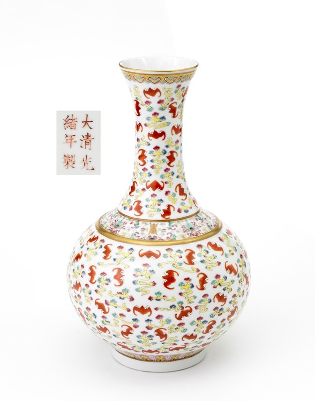 A FAMILLE ROSE BOTTLE VASE ,GUANGXU MARK IN IRON R: The globular body colorfully enamelled with a dense pattern of iron-red bats in flight amidst trailing multicolored clouds, between borders of stylized lappets around the base and a band of gilt shou