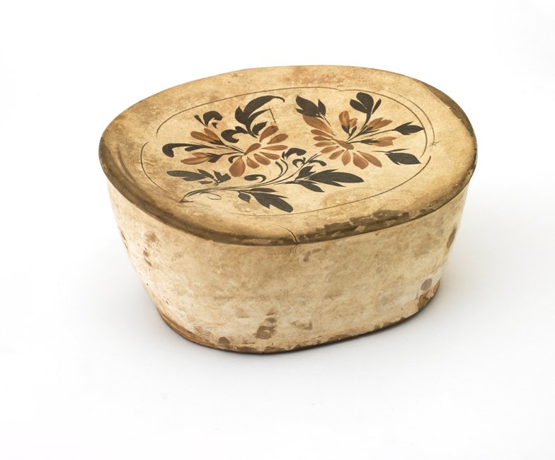 A CIZHOU-TYPE POTTERY PILLOW,SONG JIN DYNASTY : painted with flowering sprays on the top of pillow,5''x10 5/8''x9 7/8''