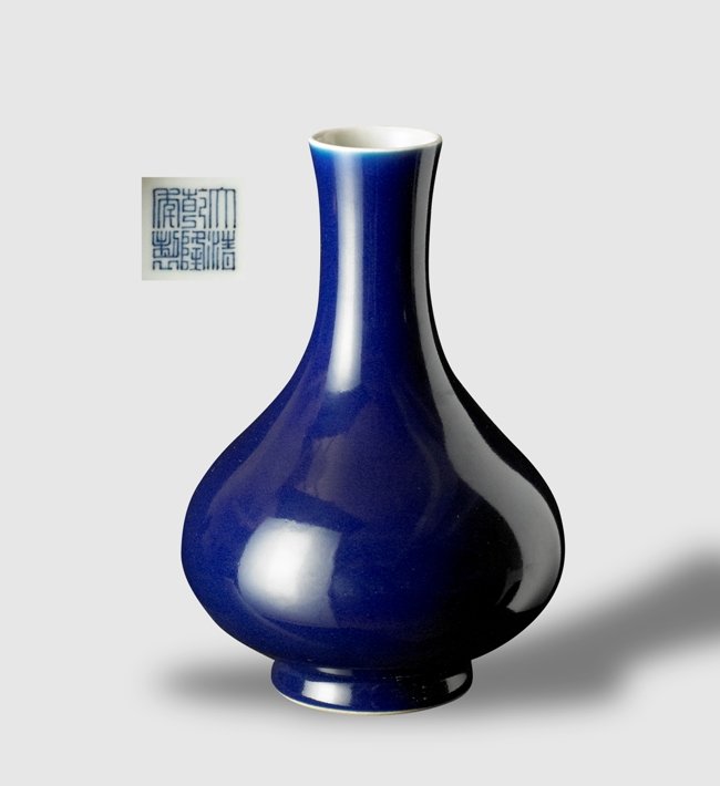 A BLUE GLAZED BOTTLE VASE,QIANLONG SEAL MARK AND P: The compressed globular body raised on a slightly spreading foot and surmounted by a cylindrical neck with flared rim, the exterior covered in a glaze of rich blue color, the mouth rim and interior wh