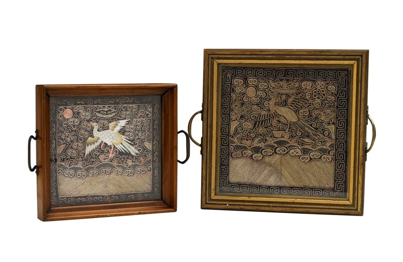 Two of silk military badges of ranks,buzi, 19th Ce: 19th Century one embroidered with a peacock in satin stitch and couched gold threads amidst auspicious objects and clouds worked in Peking knot, standing atop rocky outcrops above crashing waves and t