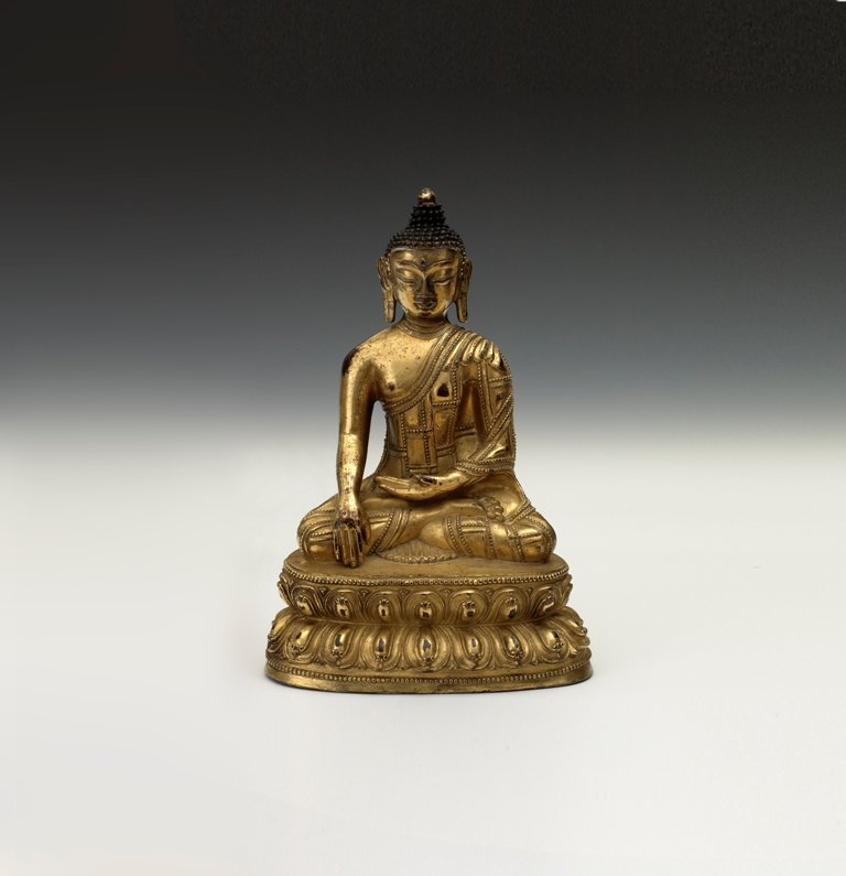 A gilt bronze figure of Buddha, NEPAL, Qing dynast: NEPAL, Qing dynasty Gilt overall, seated in dhyanasana on a double-lotus base with deeply cast petals and beaded rims, wearing an ornate patchwork sanghati with beaded decoration, the hands held in dh