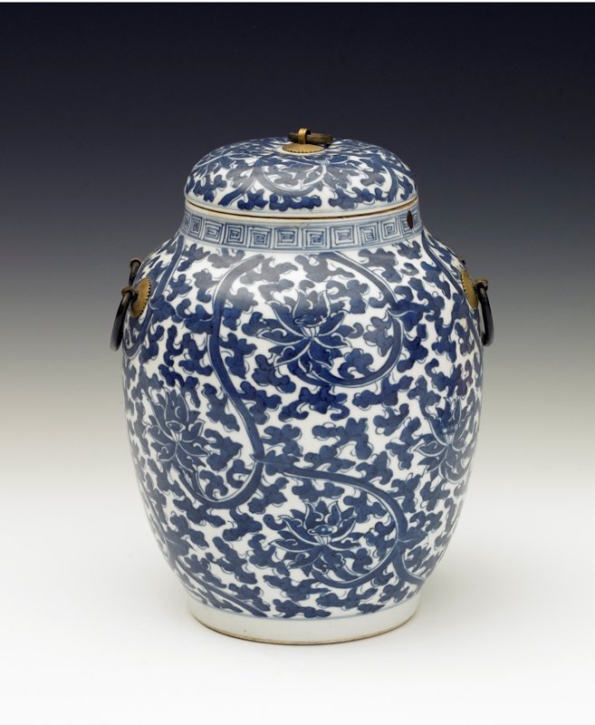 A blue and white jar and cover, Qing Dynasty: Qing Dynasty Painted with clustered prunus sprays on a blue 'ice-crack' ground, with similarly decorated flattened cover. H: 10 3/8 in