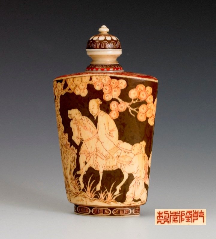 A clored ivory snuff bottle, 19TH CENTURY: 19TH CENTURY Brown tone background overall decorated with a scene of a man on a horse and two other individuals accompany him on the journey. Four Chinese Characters on the bottom. 3 3/4 in. tall.
