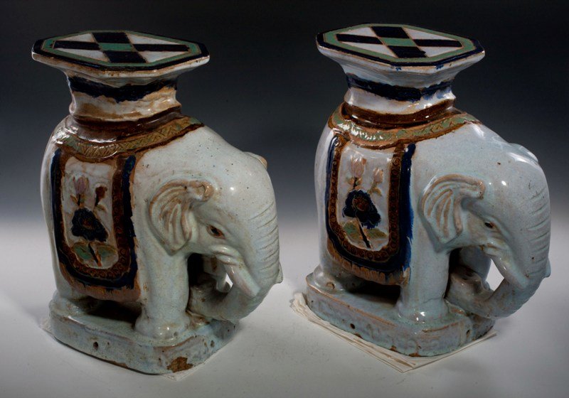 A pair of shiwan glazed flower stands, 19TH CENTU: 19TH CENTURY Each molded in an elephant-shapped with the "trunk" touching the front legs,covered by a colorful shiwan glaze 16'' tall
