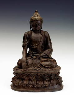 A bronze figure of Buddha, JIAJING PERIOD: JIAJING PERIOD Seated in dhyanasana position on a double lotus base, wearing ancient robe, beaded hair, large earlobes, eyes closed. Six Chinese characters on the edge of the lotus base. 11 3/4''tall