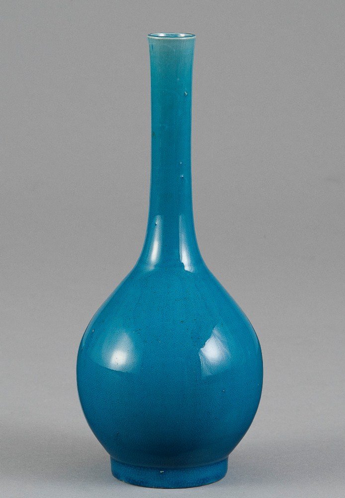 A BLUE GLAZED BOTTLE VASE: QING DYNASTY The vase is pear- shaped with a long neck. The exterior of the vase is decorated with a solid sky blue colour tone. 9 9/16 in. (24.3 cm) tall. 清代 孔雀藍