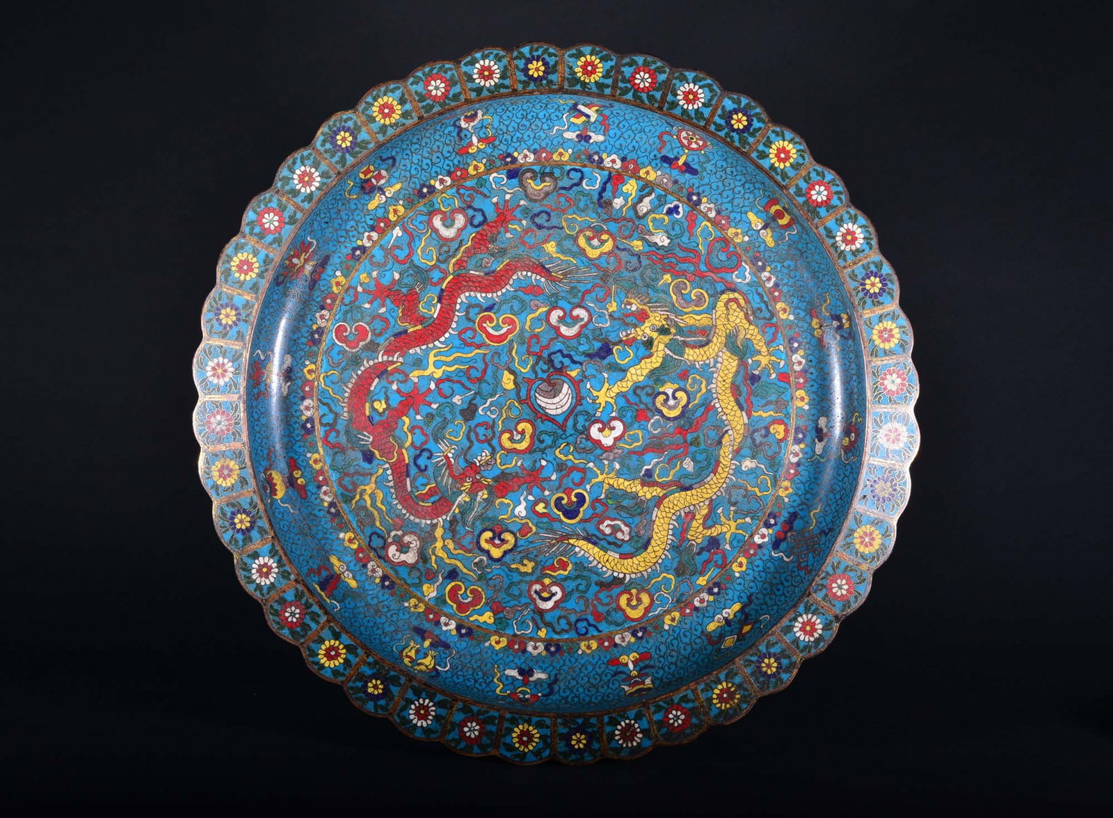 A Cloisonne Enamel Bronze Dragon Dish 16th Century: The central interior medallion is decorated with two dragons and contesting the flaming pearl amongst ruyi-clouds and flames, encircled by a band of bajixian. The exterior is decorated with a similar 