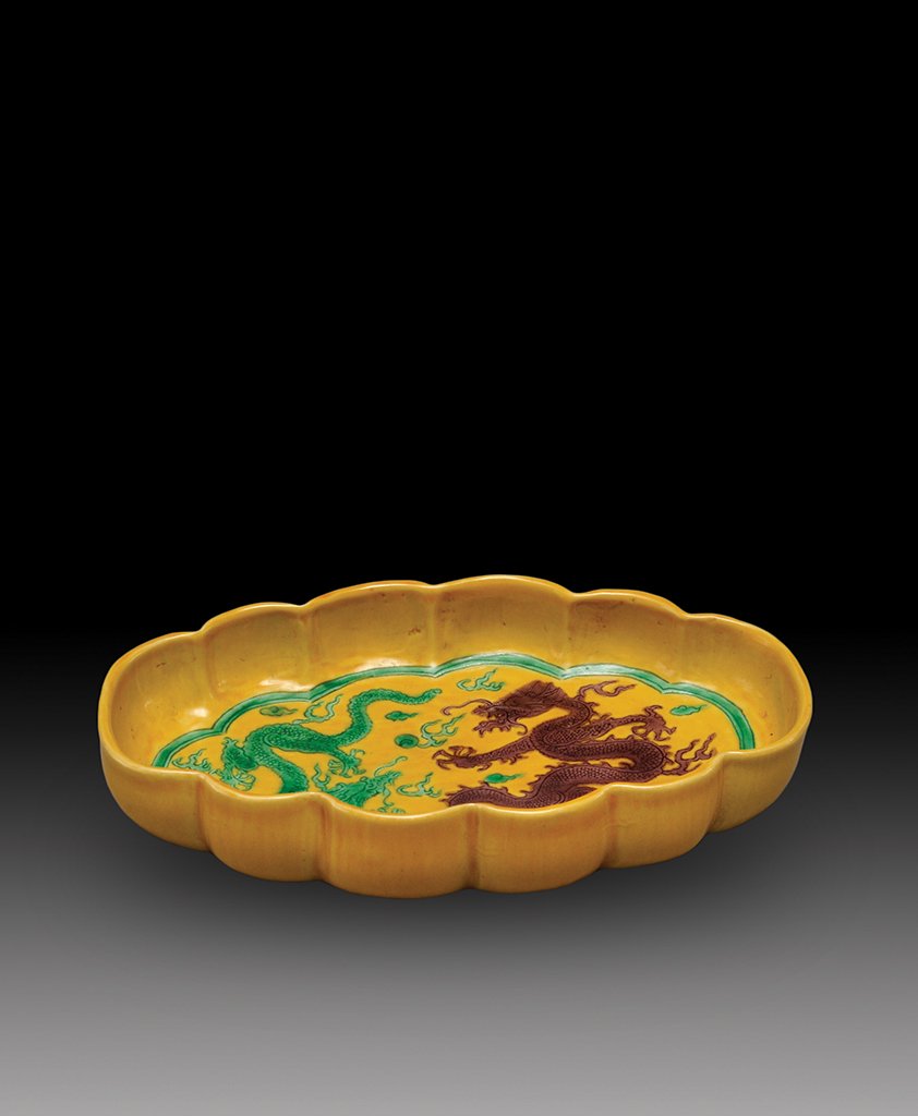 A YELLOW-GROUND DRAGON BRUSHWASHER: MARK AND PERIOD OF YONGZHENG The plate is of oval- shaped and overall a bright yellow color tone. The interior is decorate with a green and purple dragons. 6 3/4 in. (17.2 cm), 4 in. (10.1 cm), 1 3/16