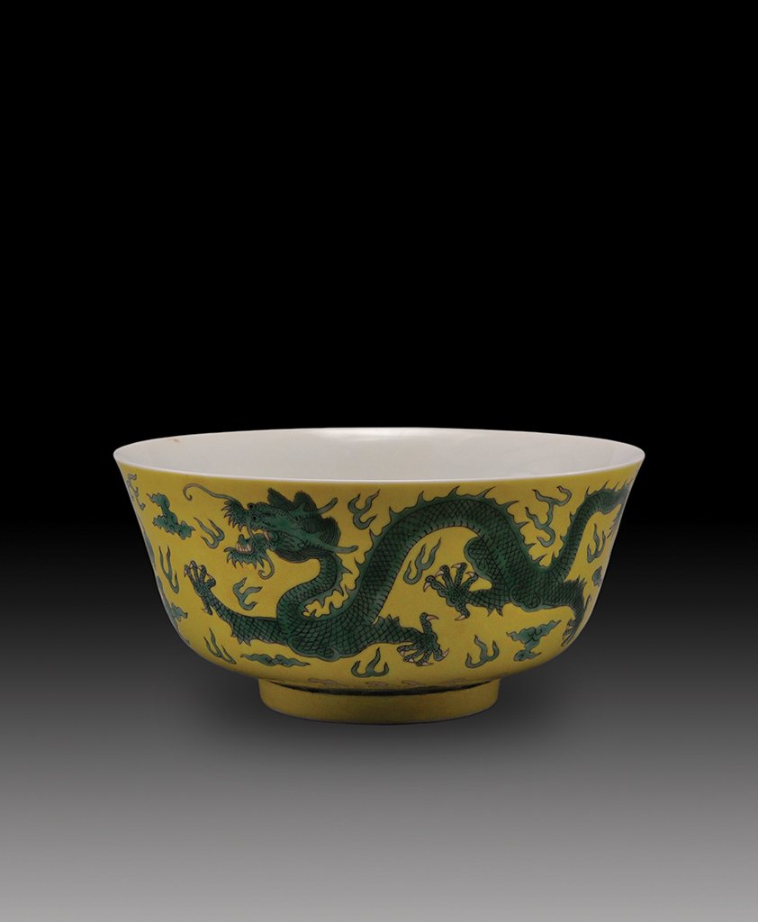 A YELLOW-GROUND-GREEN-GLAZED DRAGON BOWL: MARK AND PERIOD OF GUANGXU The bowl is of concave- shaped and is decorate with twin green dragons chasing pearls. 7 1/4 in. (18.6 cm) diameter, 3 1/2 in. (9 cm) tall.