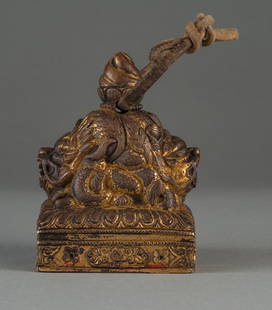 A TIBET GILT-BRONZE TEMPLE DRAGON SEAL: 18TH CENTURY The seal is of bronze brown color tone overall, on both side of the seal is decorated with a dragon's head. Above the two head is a carving of torch. The base of the seal is a carving of