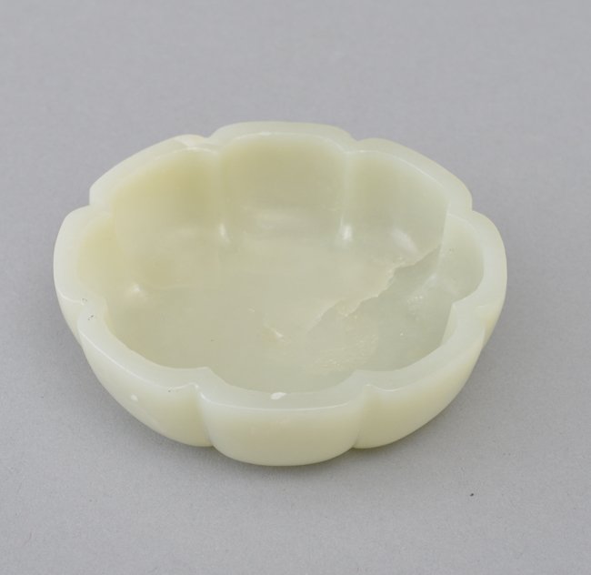 A WHITE JADE BRUSH WASHER: The well polished translucent stone with a pale celadon tinge. 3 5/8 in. (9.2 cm) diameter.
