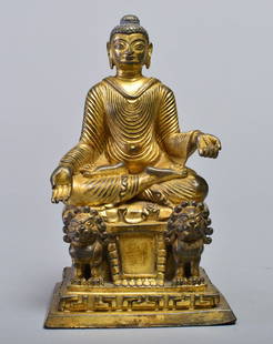 A GILT-BRONZE FIGURE OF BUDDHA SAKYAMUNI: 15-16th CENTURY Seated in meditation on a pedestal,with two hands in mudra of teaching ,he shows a meditative face,with raised urna and the ushnisha topped by a round jewel finial,the quadrate sumeru