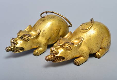 A PAIR OF GILT-BRONZE RATS: QING DYNASTY Each modeled with head facing upward and with food in the mouth,light yellow color glt all over the body with small dots pattern with a long tail behind. 12 13/16 in. (32.5 cm) long.