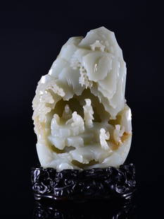 A CARVED WHITE JADE 'LANDSCAPE AND FIGURE' MOUNTAIN: Qing Dynasty the jade carving is of white jade colour tone with natural dark inclusions. The carving is of numerous scholars socializing. The scholars are also surrounded with a nature setting. The