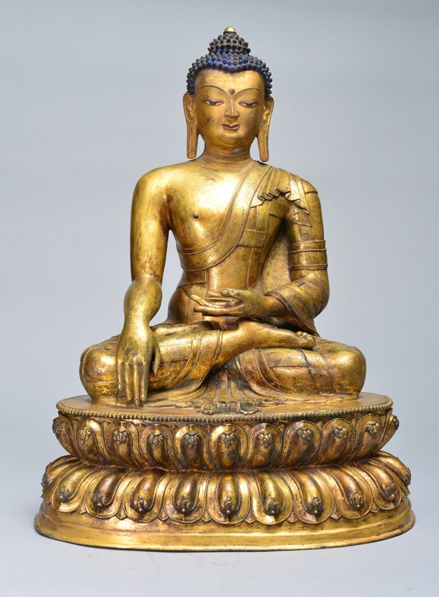 A LARGE GILT-BRONZE FIGURE OF SAKYAMUNI BUDDHA: Ming Dynasty Very finely cast seated in dhyanasana atop a double-lotus base with beaded rims, the Buddha's hands in the gestures of dhyana mudra and bhumisparsha mudra, wearing a long flowing robe ove