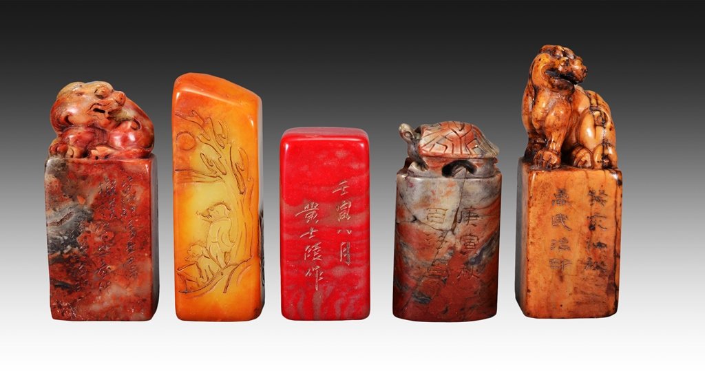 A GROUP OF FIVE SOAPSTONE SEALS: The soapstones are rectangular-shaped. The exterior is decorated with many colors and numerous Chinese characters, the first and last one has lions on the top and fourth one has a turtle. Also on the 