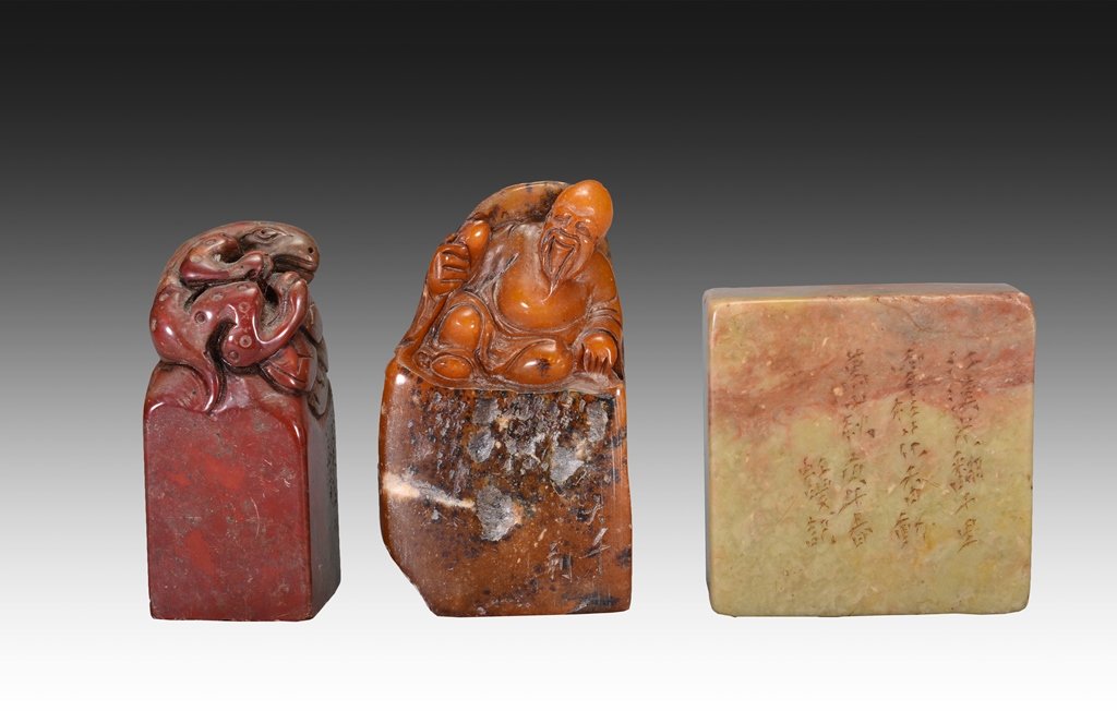THREE OF CARVED SOAPSTONE SEALS: The carved soapstones rectangular-shaped. The exterior is decorated with many colors and the third is designed with numerous Chinese characters, the first has a sheep and second one has an old man on 