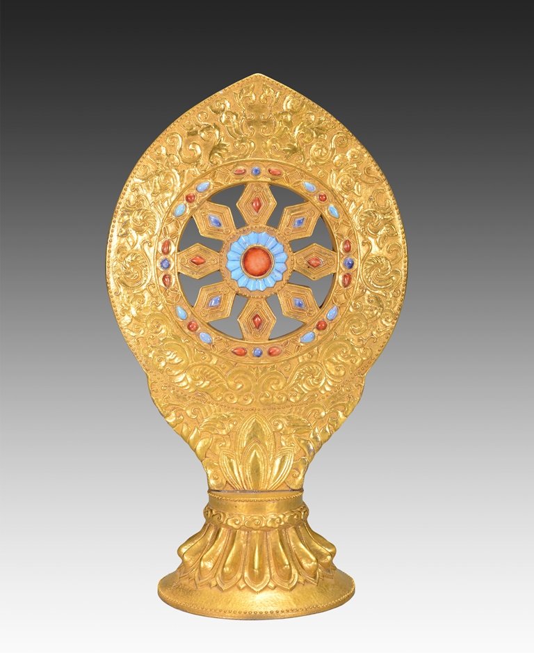 A GILTED AND POLYCHROME-ENAMELLED BUDDIST ALTAR: Qing Dynasty The alter is irregular-shaped. The exterior is decorated with a lotus circle connected with seven hexagonal-shaped pieces with amber, blue, orange, and red gems on an surrounding the alta