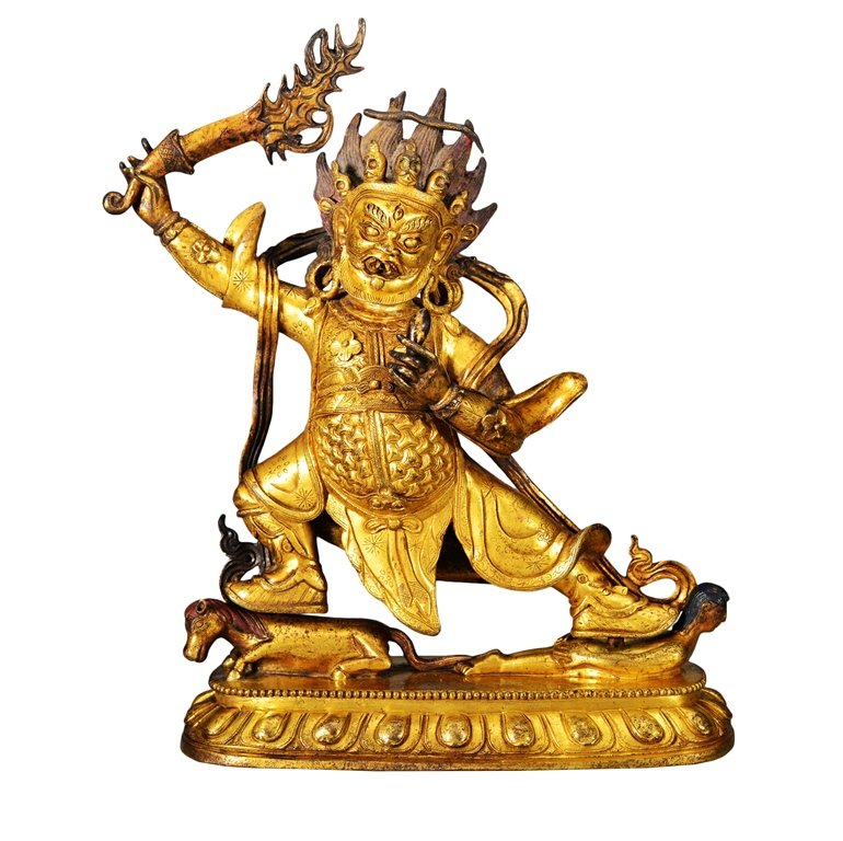 A GILT BRONZE FIGURE OF BEGTSE: The gilt bronze figure is standing right knee flex and on a small seated horse. His left leg extended and on a small person which is on his stomach. The gilt bronze figure is holding a large weapon in
