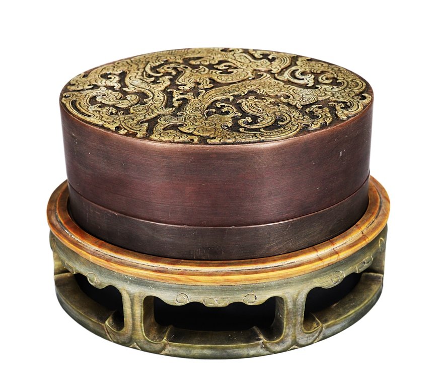 A CARVED SONGHUA INKSTONE WITH IMPERIAL INSCRIPTION: the inkstone is circular-shaped. The cover is twin dragons surrounded by ruyi clouds. The base of the inkstone is decorated with many Chinese writings. 2 3/8 in. (6 cm) tall, 6 1/16 in. (15.5 cm) wide