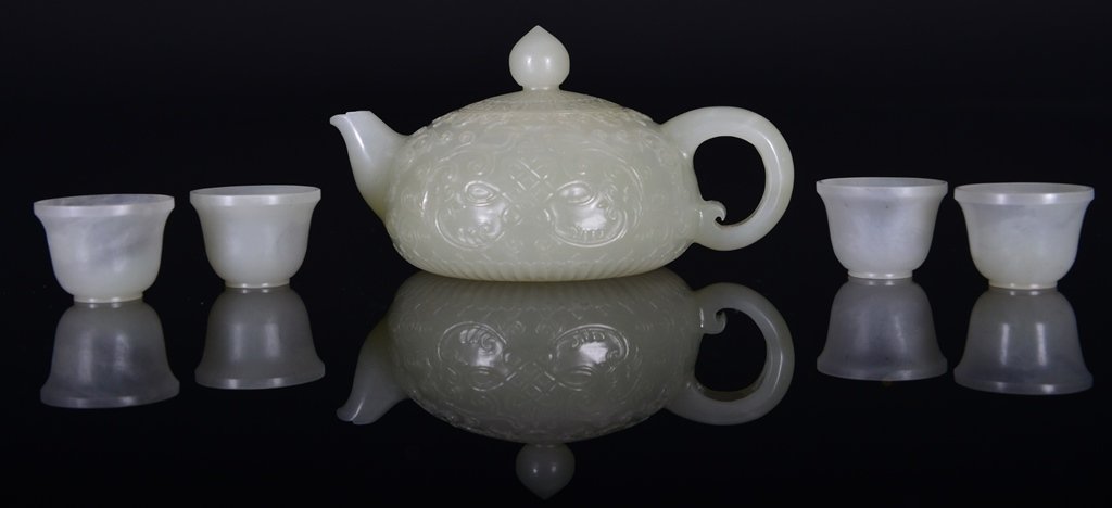 A WHITE JADE CARVING OF TEAPOT AND CUPS (1 of 5)
