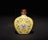 A YELLOW-GROUND FAMILLE-ROSE SNUFF BOTTLE