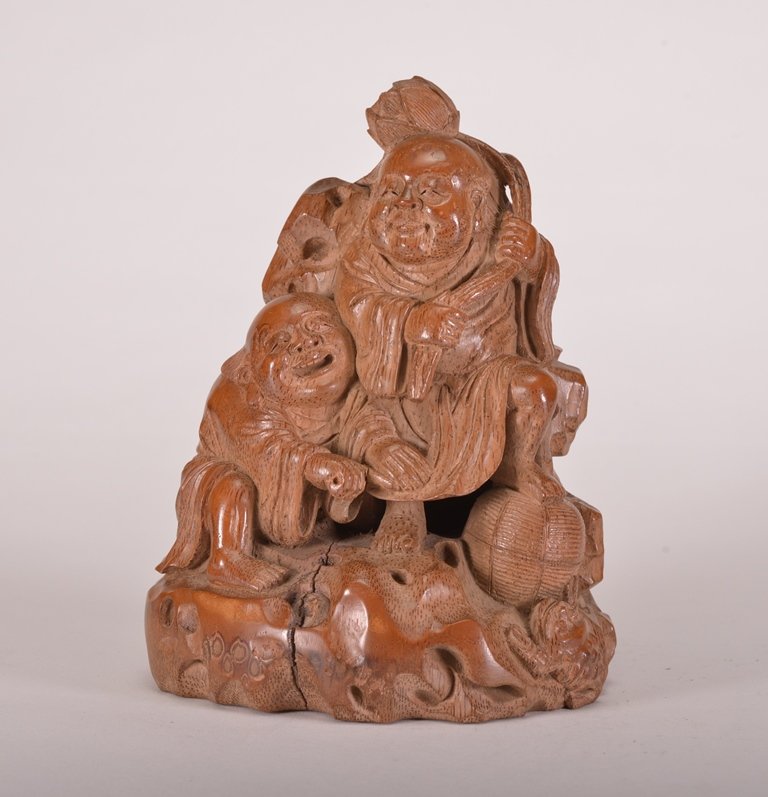 A BAMBOO CARVING OF HEHE: The carving is two scholars sitting next to each other wearing traditional robes. Qing Dynasty 7 3/8 in. (18.7 cm) tall.
